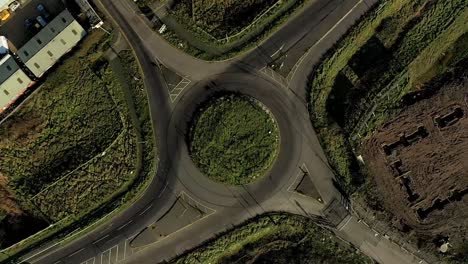 Aerial-:-spinning-rotation-above-roundabout-as-cars-enter-and-exit