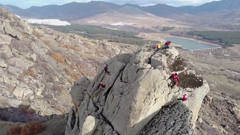 Rescue-team-climbing-on-a-vertical-rock-with-ropes-and-equipment