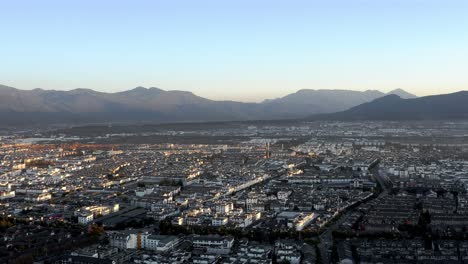 Aerial:-Lijiang-city-in-Yunnan-China,-sunset-cityscape-view