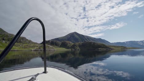 Cruising-Ship-Towards-Lush-Mountains-On-Pristine-River-During-Sunny-Day-In-Norway