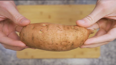 Close-up-of-a-man-holding-a-sweet-potato