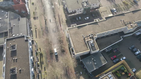 Top-down-aerial-of-empty-small-shopping-district-in-suburban-area-during-Covid-lockdown