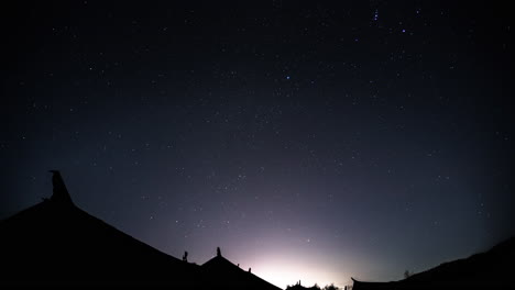 Stars-time-lapse-over-traditional-Chinese-village-house-rooftops,-night-skyscape