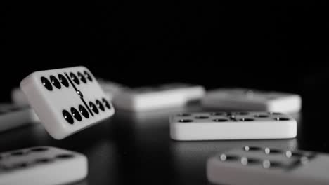 White-domino-dice-fall-on-a-black-background