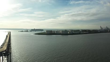 Aerial-:-drone-shot-with-pier-to-left-and-industry-and-tankers-in-distance