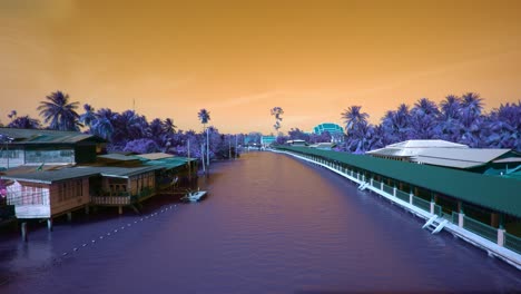 A-river-flowing-through-a-tropical-community-with-houses-on-stilts-and-abstract-color-effect-making-the-landscape-purple-and-the-sky-burnt-orange