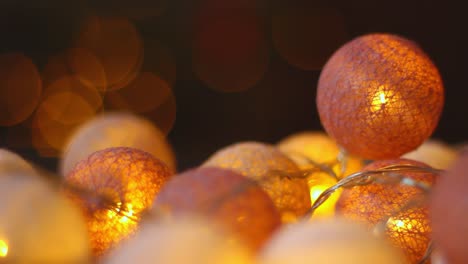 Teal-orangy-ball-fairy-lights-flaring-for-holiday-christmas-closeup