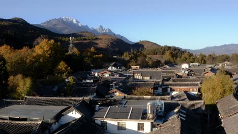 Chinese-ancient-town-Shuhe,-Jade-Dragon-Snow-Mountain-background,-aerial-view