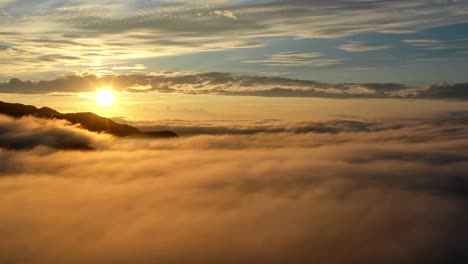 Sea-of-clouds-moving-over-the-mountains-at-sunset---Time-lapse---North-Norway