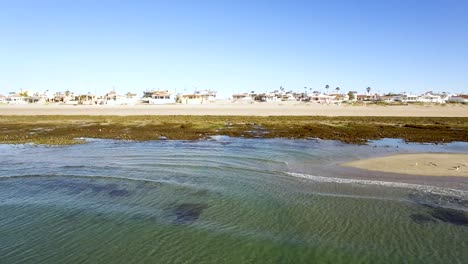 Aerial-pan-down-the-intertidal-beach-exposed-by-low-tide,-Rocky-Point,-Puerto-Peñasco,-Gulf-of-California,-Pacific-Ocean,-Mexico