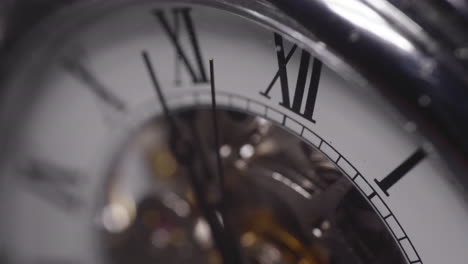 Seconds-hand-crossing-a-number-on-a-shiny-chrome-watch---Macro-shot