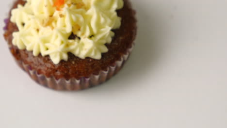 Carrot-Walnut-Cupcake-Topped-With-Icing,-top-view,-studio-shot
