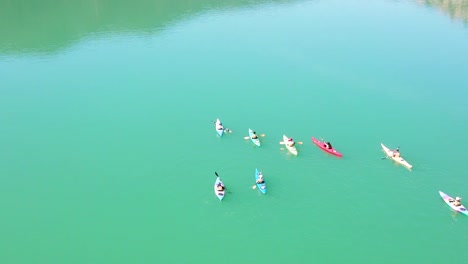 Fun-moment-young-and-adult-people-paddling-kayak-in-the-lake-of-the-Barcelona-mountains