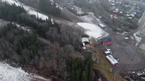 Aerial-reveal-shot-of-Swedish-Ski-resort-in-Winter-with-little-snow