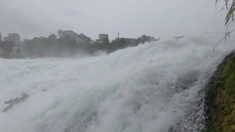 Foamed-water-of-Rhine-Falls,-rapid,-strong,-powerful-waterfall-close-up