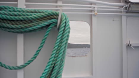 Old-Rugged-Boat-Rope-On-Vessel-Sailing-During-Daytime-In-Norway