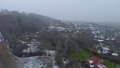 Drone-descending-over-Ski-Resort-and-village-lacking-Snow-in-Winter