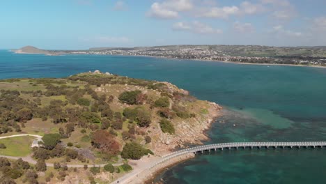 Causeway-from-Victor-Harbor-to-Granite-Island-aerial-view,-Australian-coast