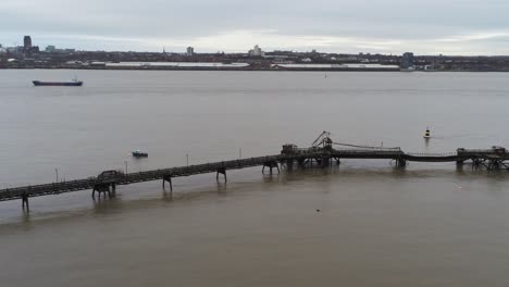 Drone-view-Tranmere-oil-terminal-Birkenhead-coastal-petrochemical-harbour-River-Mersey-distribution-Liverpool-skyline