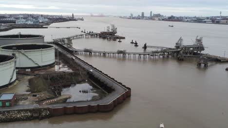Drone-view-dolly-left-across-Tranmere-oil-terminal-Birkenhead-coastal-petrochemical-harbour-distribution