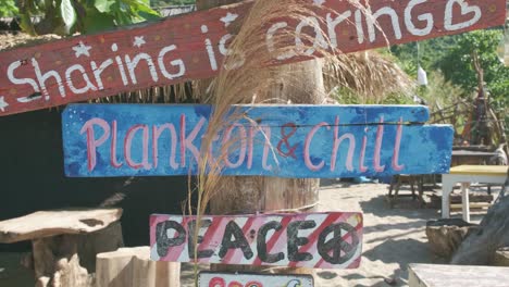 static-shot-of-wooden-signs-on-the-beach-at-a-beach-bar-that-is-closed-due-to-the-pandemic-in-Thailand