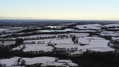 Snowy-winter-patchwork-Lancashire-agricultural-farmland-rural-countryside-landscape-pan-right