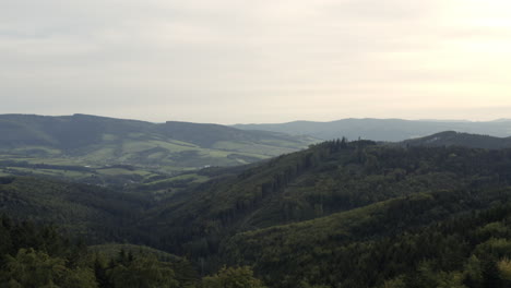 Fast-forward-aerial-of-hilly-green-forest,-cloudy-day,-Czech-Republic