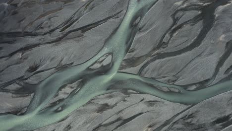 Glacial-river-melt-water-with-mineral-sediment-flows-through-delta-in-Iceland