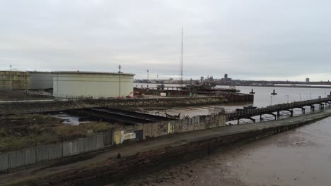 Drone-rising-view-Tranmere-oil-terminal-Birkenhead-coastal-petrochemical-harbour-distribution-port