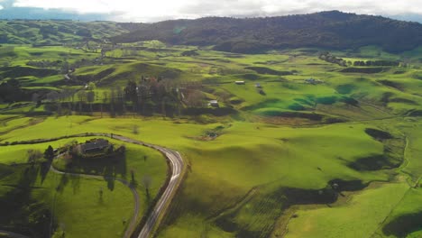 Green-rolling-hills-of-New-Zealand,-idyllic-countryside-aerial-view