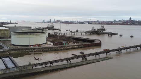 Drone-view-Tranmere-oil-terminal-Birkenhead-coastal-petrochemical-harbour-distribution-descend-pull-back