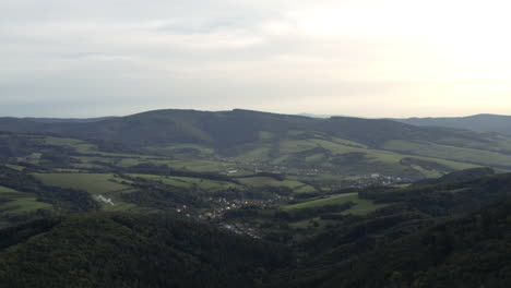 Slow-wide-aerial-of-green-hills-and-rural-village-in-Czech-Republic