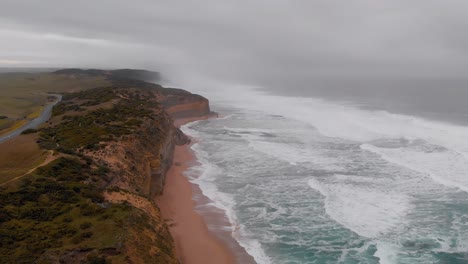 Majestic-cliffs-and-rough-ocean-aerial-view,-Twelve-Apostles,-Australia