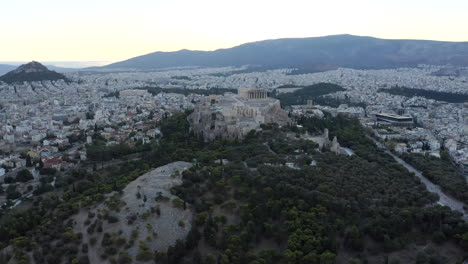 Drone-aerial-shot-flying-towards-Acropolis,-ancient-city-of-Athens,-from-above-in-ear-morning-light,-sunrise,-Greece