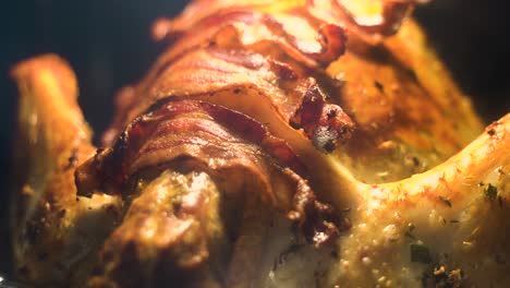Delicious-looking-turkey-covered-in-bacon-roasting-in-oven-during-Thanksgiving