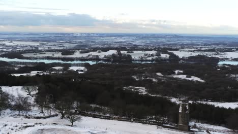 Snowy-winter-patchwork-Lancashire-farmland-rural-countryside-landscape-aerial-orbit-left