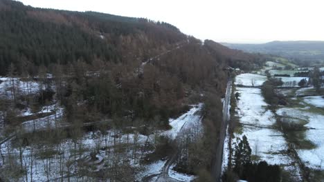 Snowy-Welsh-woodland-wilderness-Moel-Famau-winter-landscape-aerial-view-dolly-right