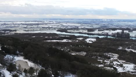 Snowy-winter-patchwork-Lancashire-farmland-rural-countryside-landscape-dolly-left-aerial-view
