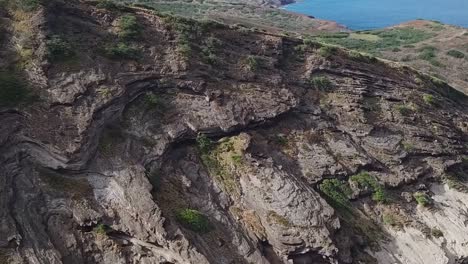 Drone-aerial-pan-down-cliff-side-beach-front