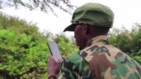 African-militant-guerilla-using-his-cellphone