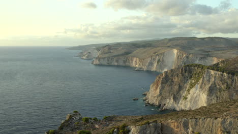 Flying-over-the-huge-Zakynthos-coastal-cliffs-on-the-west-side-at-sunset-near-Keri-cliffs