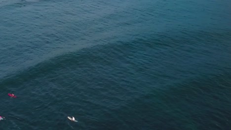 Drone-aerial-waves-sunset-surfers-on-ocean