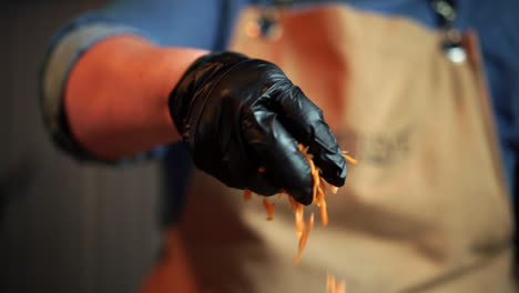 Chef-with-gloves-dressing-salad-with-carrots-slow-motion