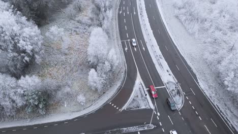 Snowy-Winter-Scene-on-Sweden-Interstate-Highway-Intersection-Roads,-Aerial