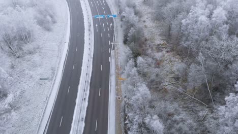 Highway-Interstate-Road-in-Snowy-Wintry-Sweden-Landscape---Aerial
