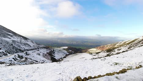 Moel-Famau-Welsh-snowy-mountain-valley-aerial-view-cold-agricultural-rural-winter-weather-scenic-view