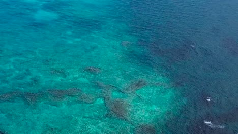 Drone-aerial-above-reef-beach-black-sand-Hawaii
