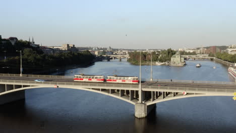Streetcar-driving-over-a-concrete-bridge,Prague,Vltava-river,Czechia