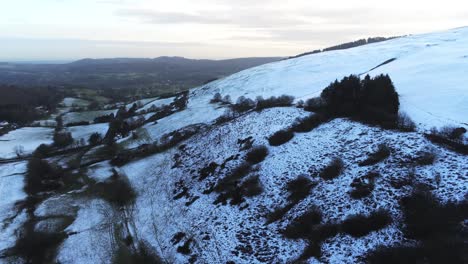 Moel-Famau-Welsh-snowy-mountain-valley-drone-view-cold-agricultural-rural-winter-landscape