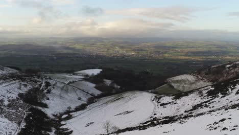 Moel-Famau-Welsh-snowy-covered-national-park-valley-aerial-view-cold-agricultural-rural-winter-landscape